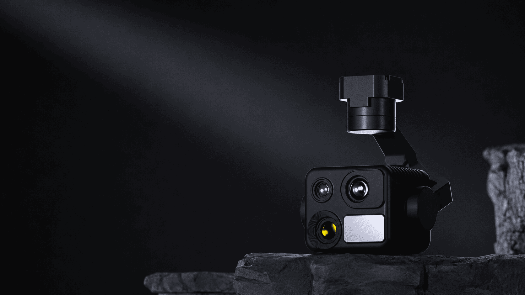 HEQ K40T quad-sensor gimbal camera on a rock in a dark setting