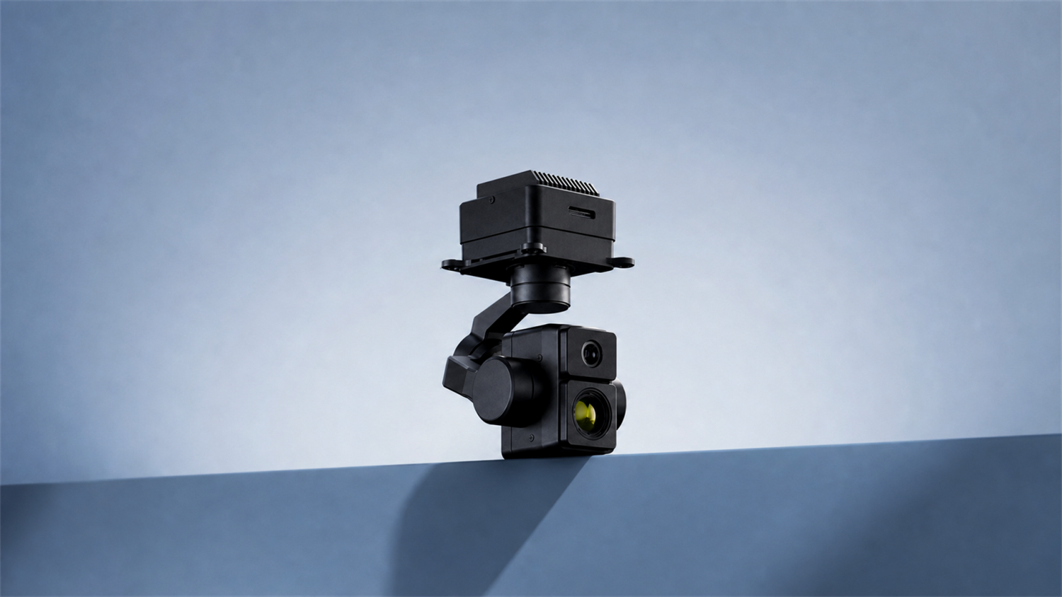 K8T-V3 dual-sensor gimbal camera for drone side view on a blue surface with blue background