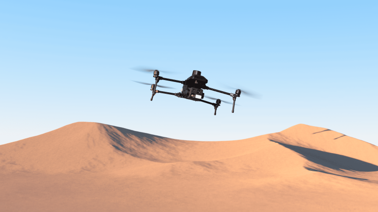 Nova-4T Quadcopter UAV platform flying in the air above the desert.
