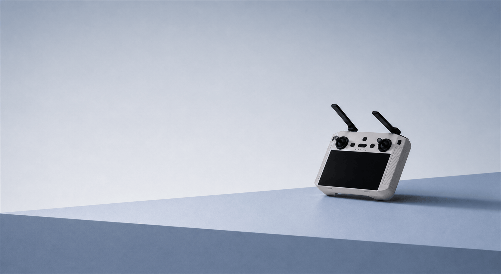 Scpeter-15, a HEQ Remote controller for UAV with two black antennas sitting on a table on blue background